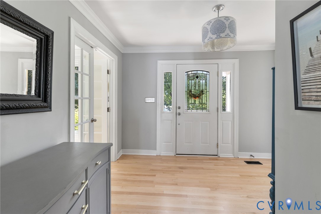 Open Entryway with home Office off the front and new finished hardwoods.
