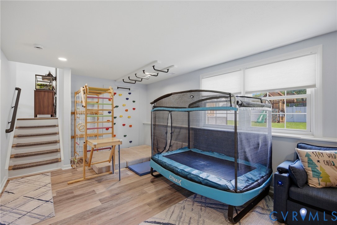 Recessed lighting illuminates wood-finish flooring