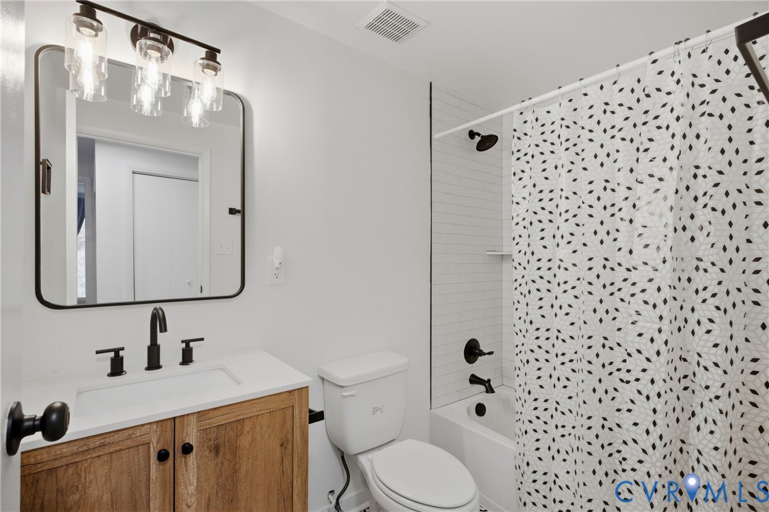 White vanity countertop with integrated sink and matte black faucet