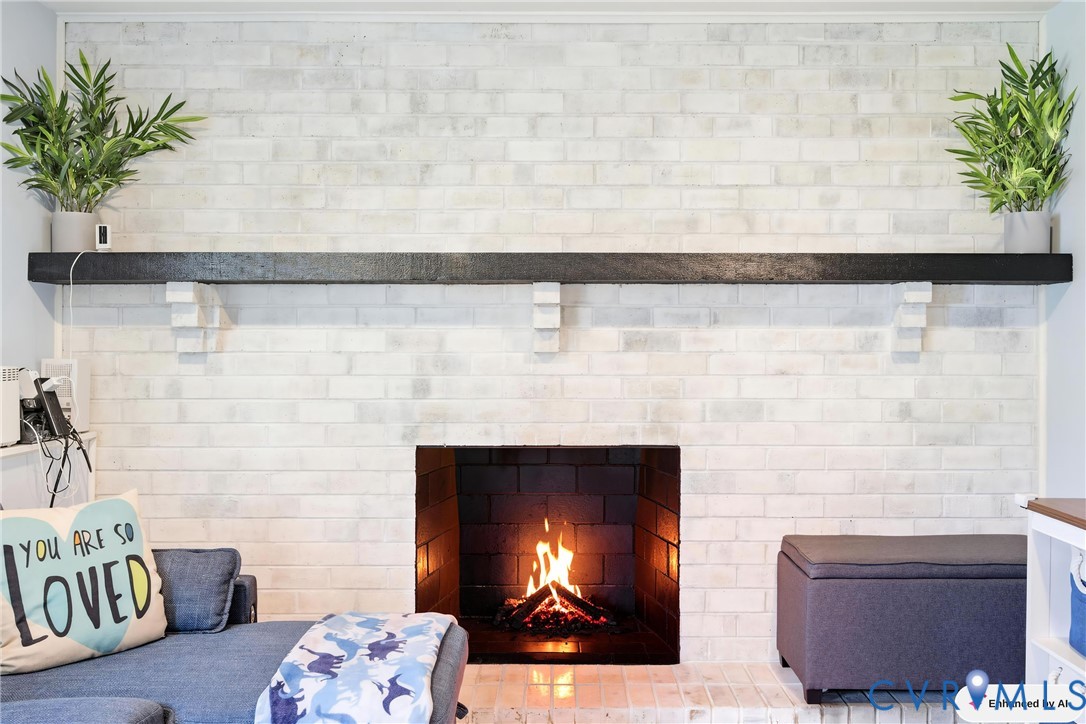 White-painted brick fireplace featuring a dark wood mantle