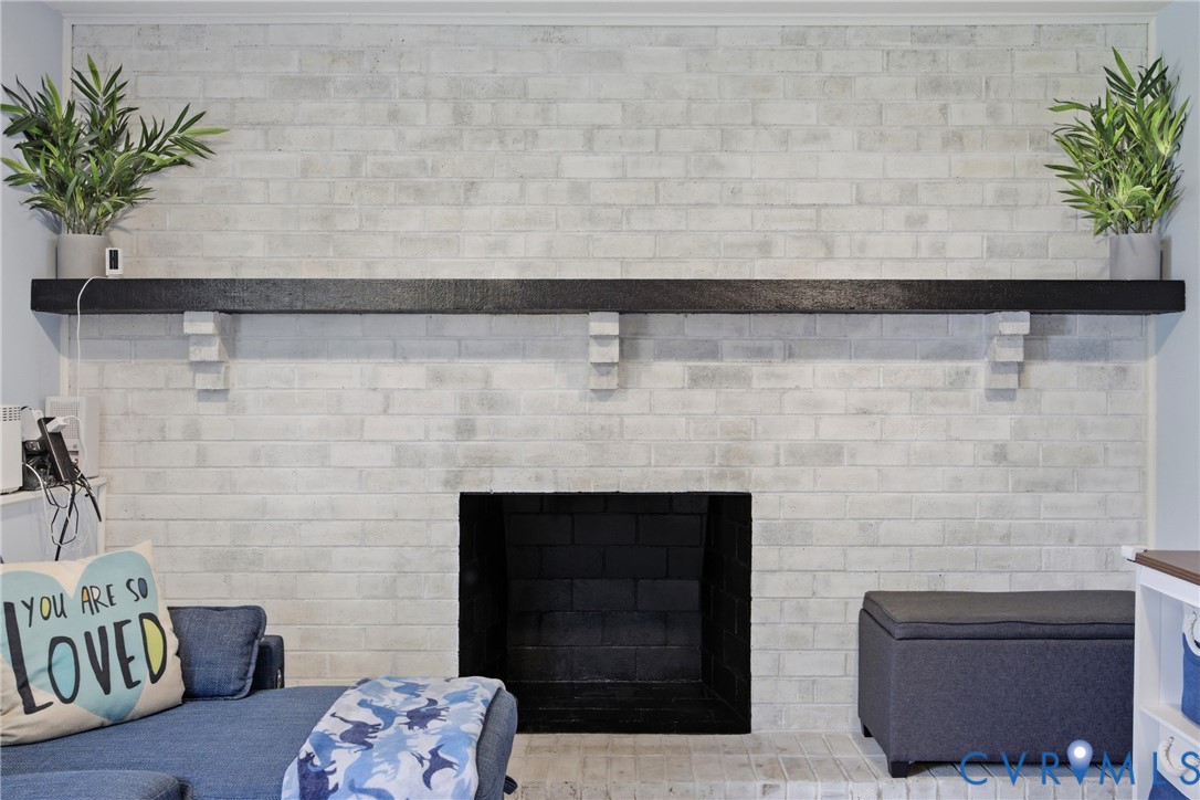 White-washed brick fireplace with a black mantel