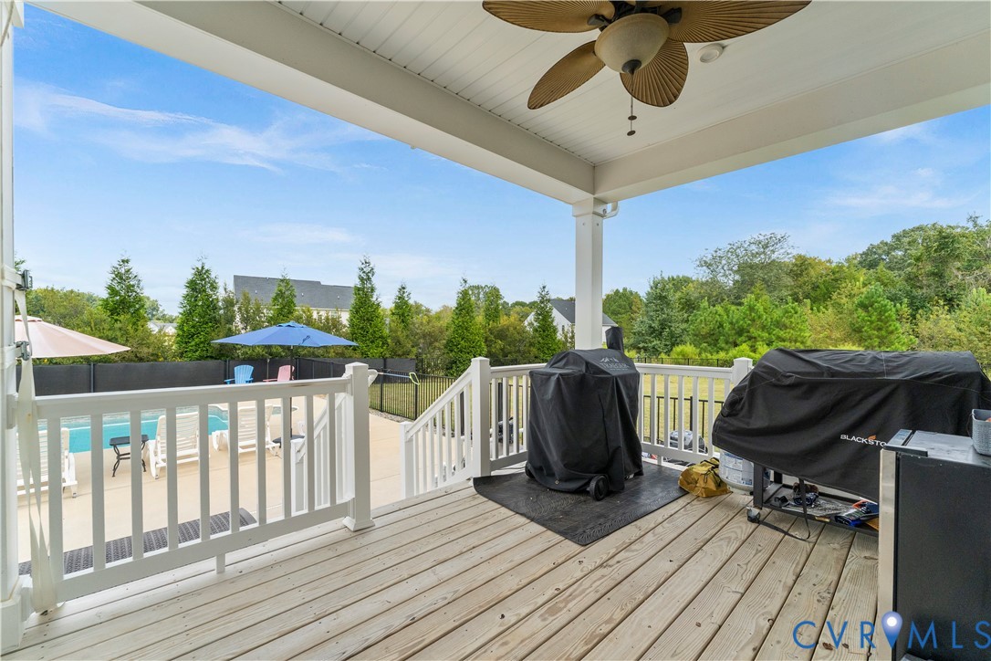 Covered porch with wood-finish decking and ceiling fan
