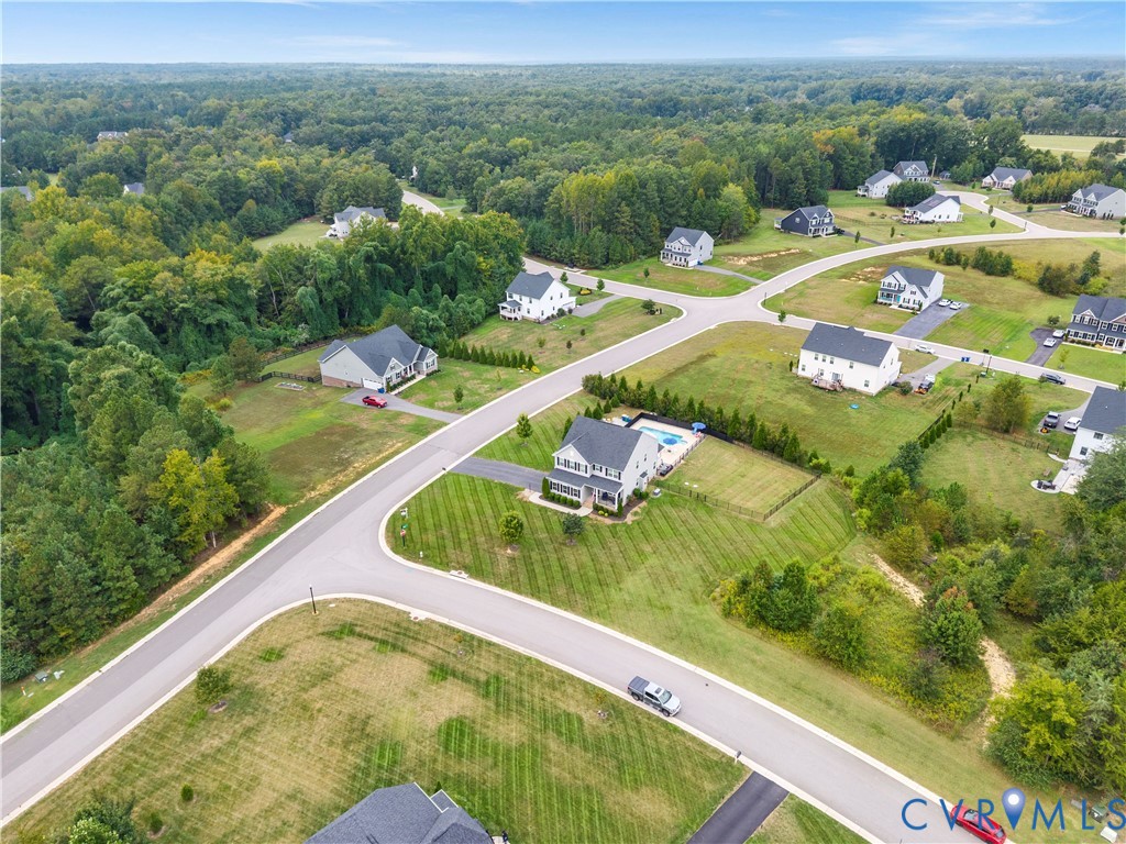 Expansive residential development featuring paved streets, individual homes, and ample green space