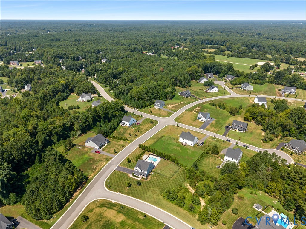 Residential properties with varied lot sizes, asphalt streets, and mature trees