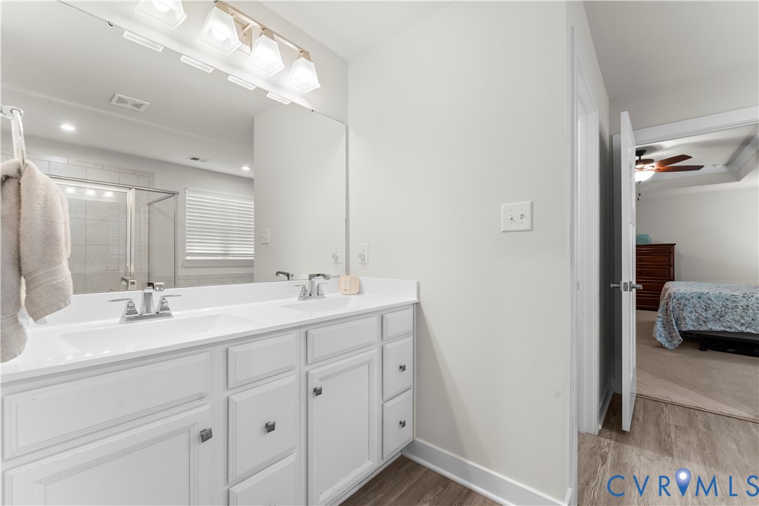 Dual vanity with white cabinetry and chrome fixtures