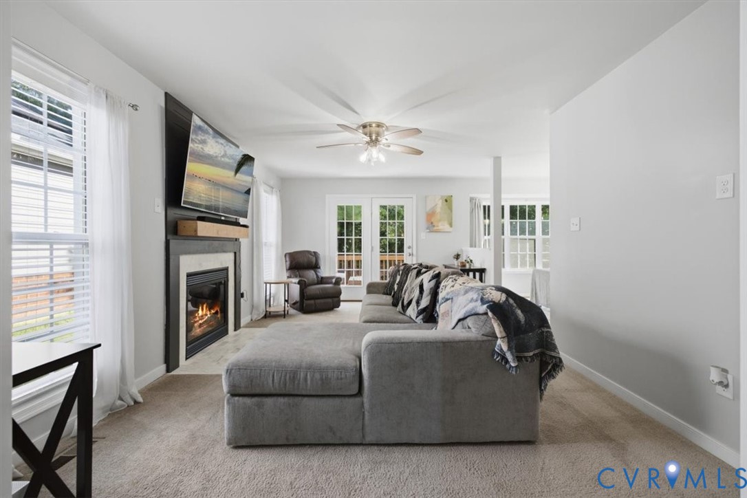 Family room right off eat in kitchen with gas fireplace and door leading to deck