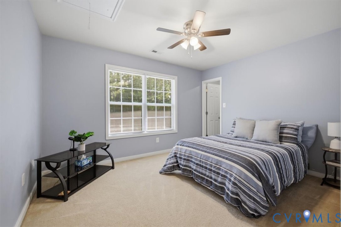 Bedroom 2 with ceiling fan and large walk in closet