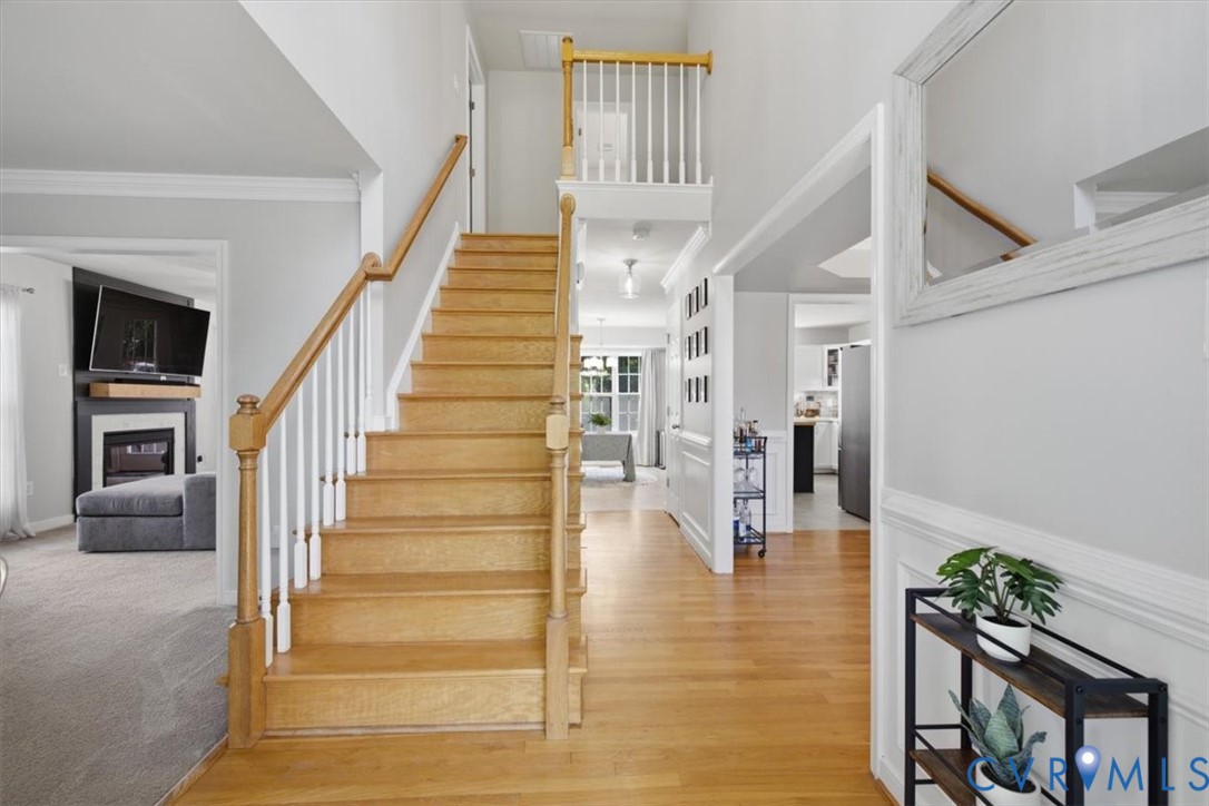 Foyer with front stairwell and wood floors