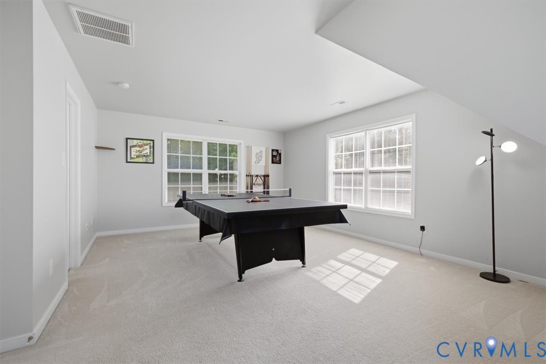 Bedroom 4 with large walk in closet, abundant natural light.  Currently used as gameroom