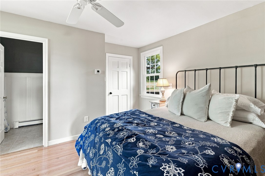 Hardwood flooring, white trim, and a ceiling fan
