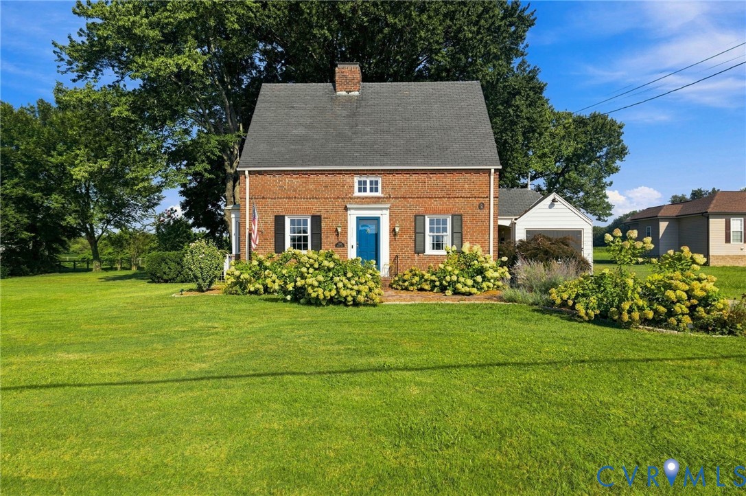 Brick exterior with a gabled roof and white window trim Brick exterior with a gabled roof and white window trim