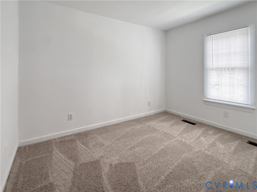 Neutral tone carpeting and white wall finishes