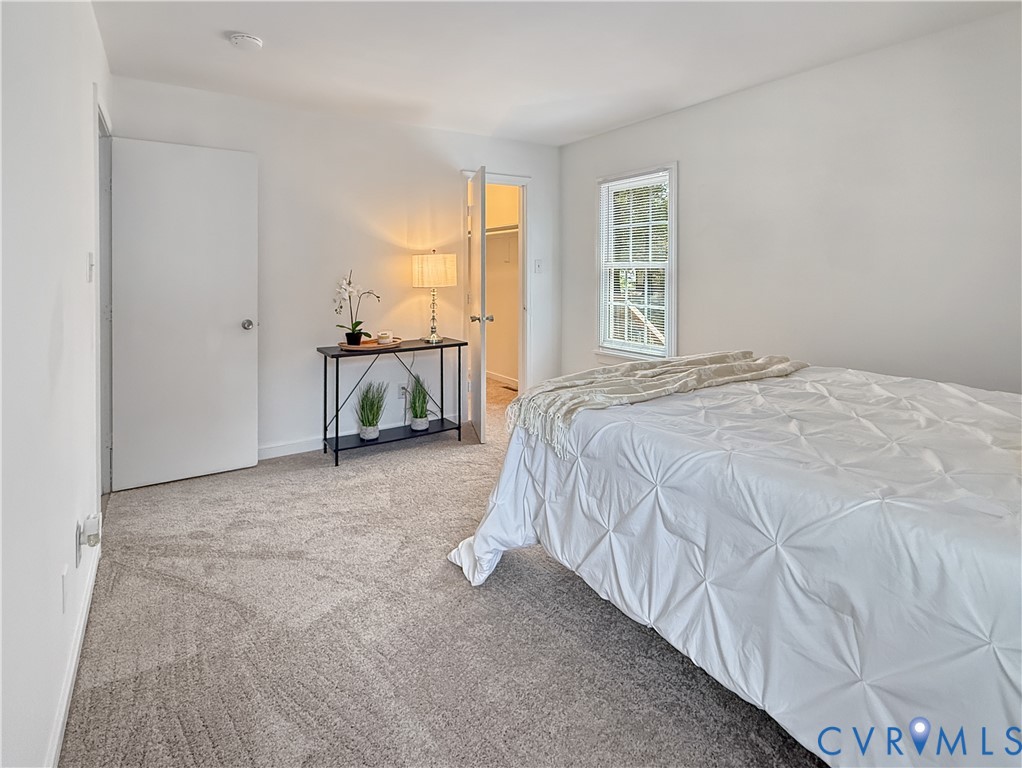 Light gray wall paint, gray carpet flooring, and a white window with grids