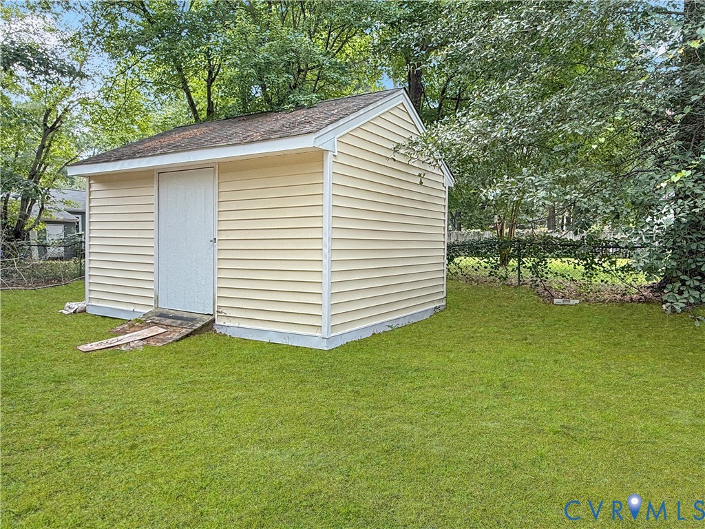 Detached storage shed with horizontal siding and a single entry door
