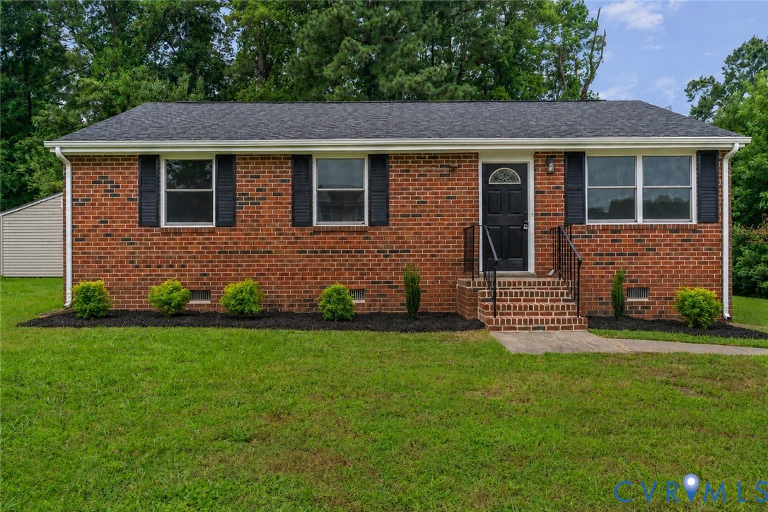 Brick exterior with black shutters and a complementary black front door