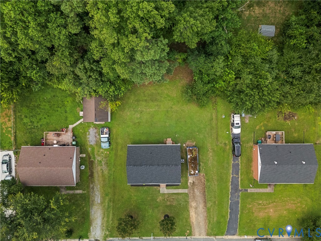 Expansive property featuring three distinct structures and significant green space
