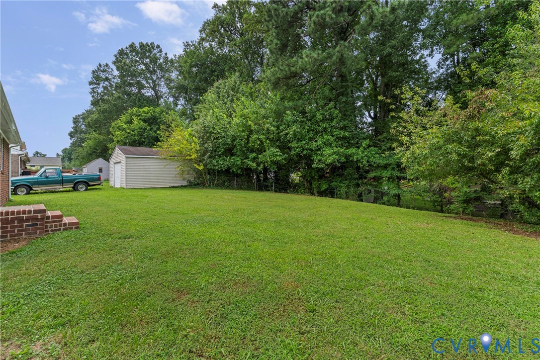 Expansive green lawn with mature perimeter trees and brickwork details