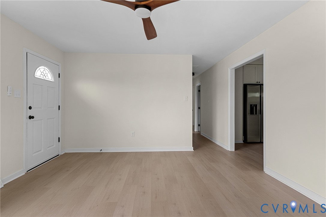 Light wood-finish flooring complements the neutral wall tones
