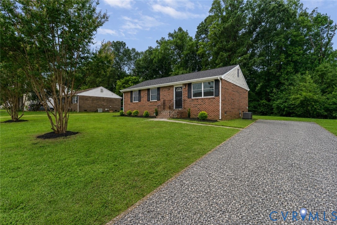 Brick exterior with black shutters and a black front door