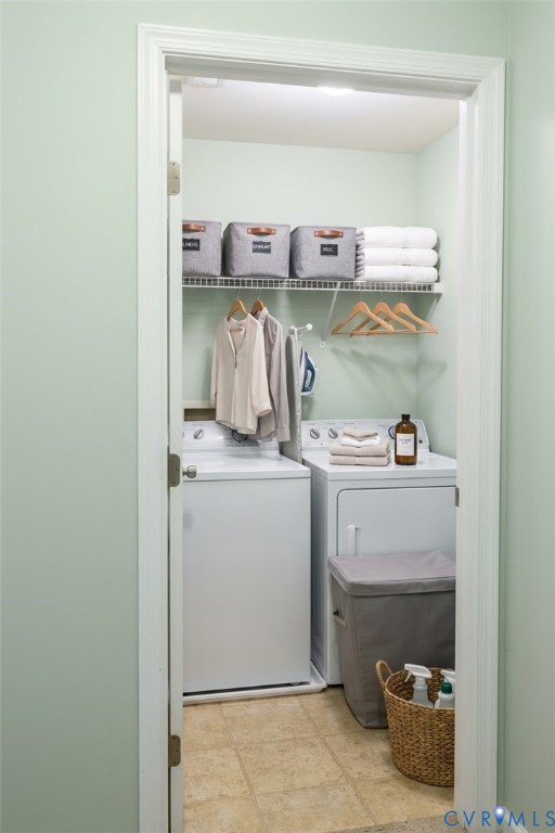 Dedicated laundry area with a washer and dryer, wire shelving, and a hanging rod