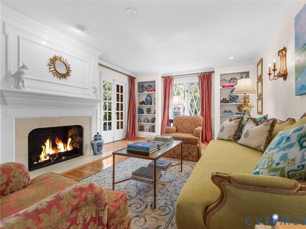 White fireplace with ornate mantel, stone hearth, and integrated firebox