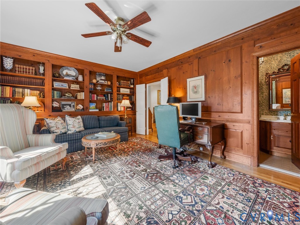 Wood paneling and built-in bookshelves define this space