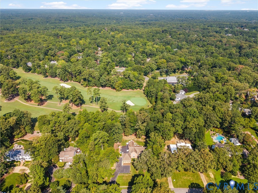 Expansive golf course frontage with mature trees and a manicured green
