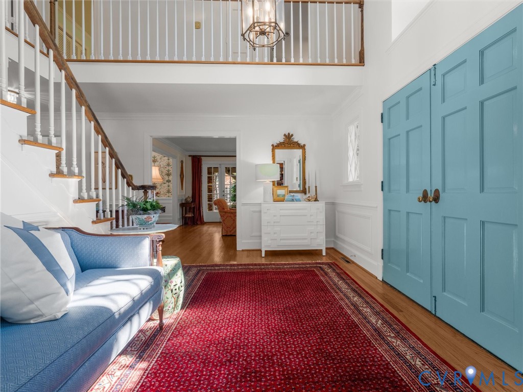 Two-story foyer with a staircase featuring wood treads and white balusters