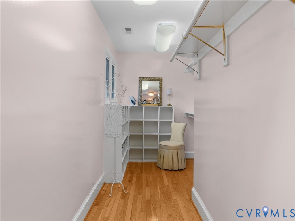 Hardwood-finish flooring, built-in shelving, and a window for natural light