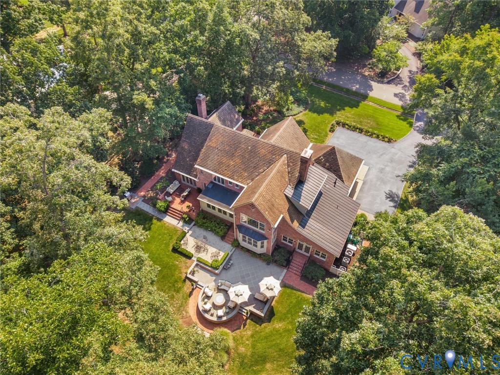 Expansive property featuring a brick exterior and multiple patios