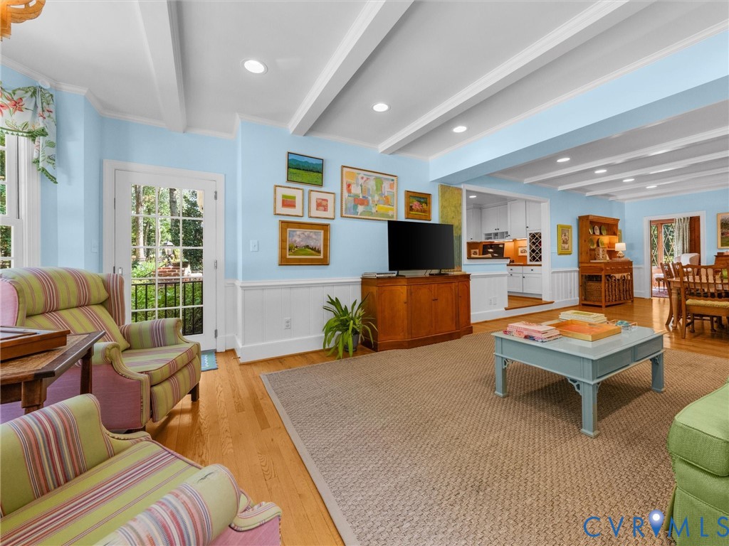 Hardwood flooring, white coffered ceiling, french doors, white wainscoting, built-in cabinetry