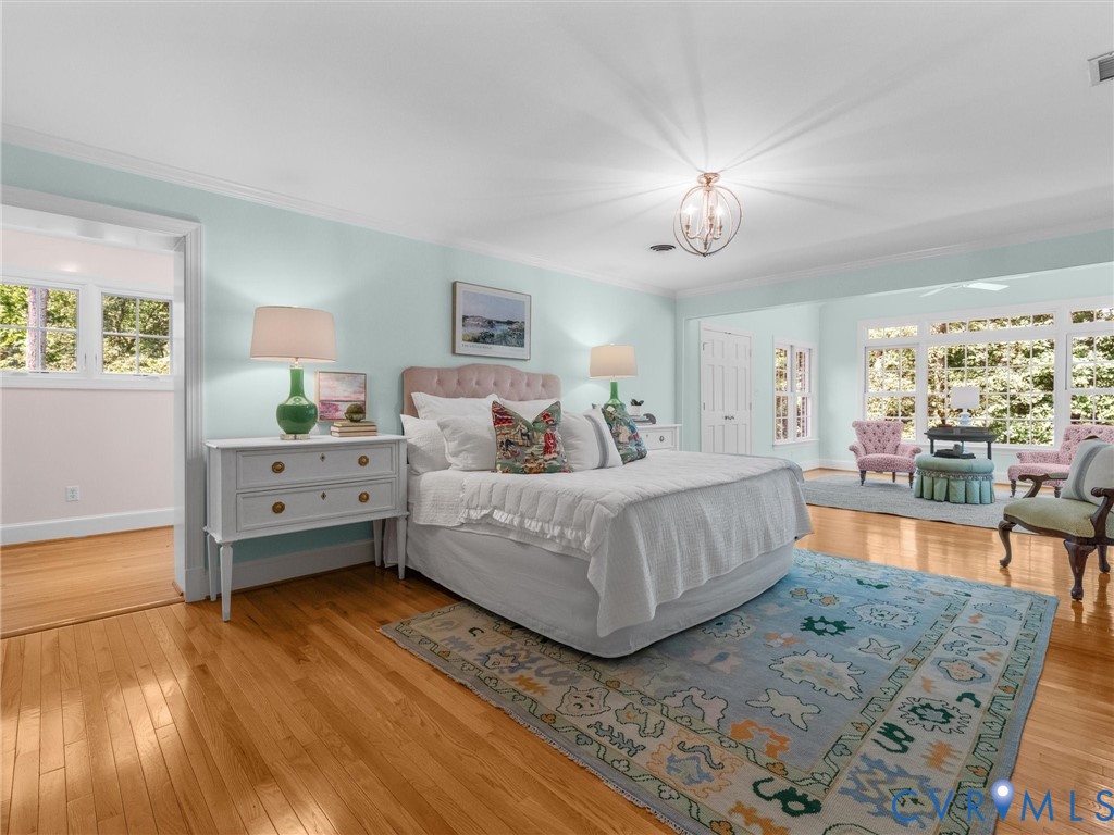 Hardwood flooring, recessed lighting, crown molding, double-door closet, and large window banks