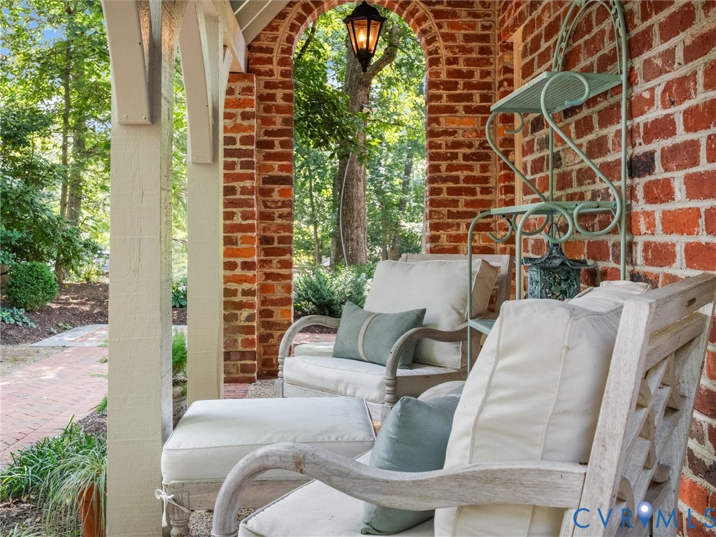 Brick archway with an overhead light fixture, providing exterior illumination