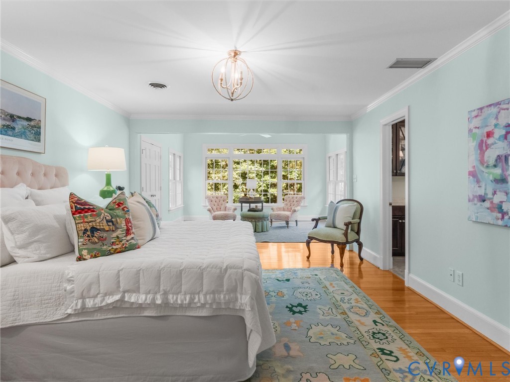 Recessed lighting, crown molding, and wood-finish flooring