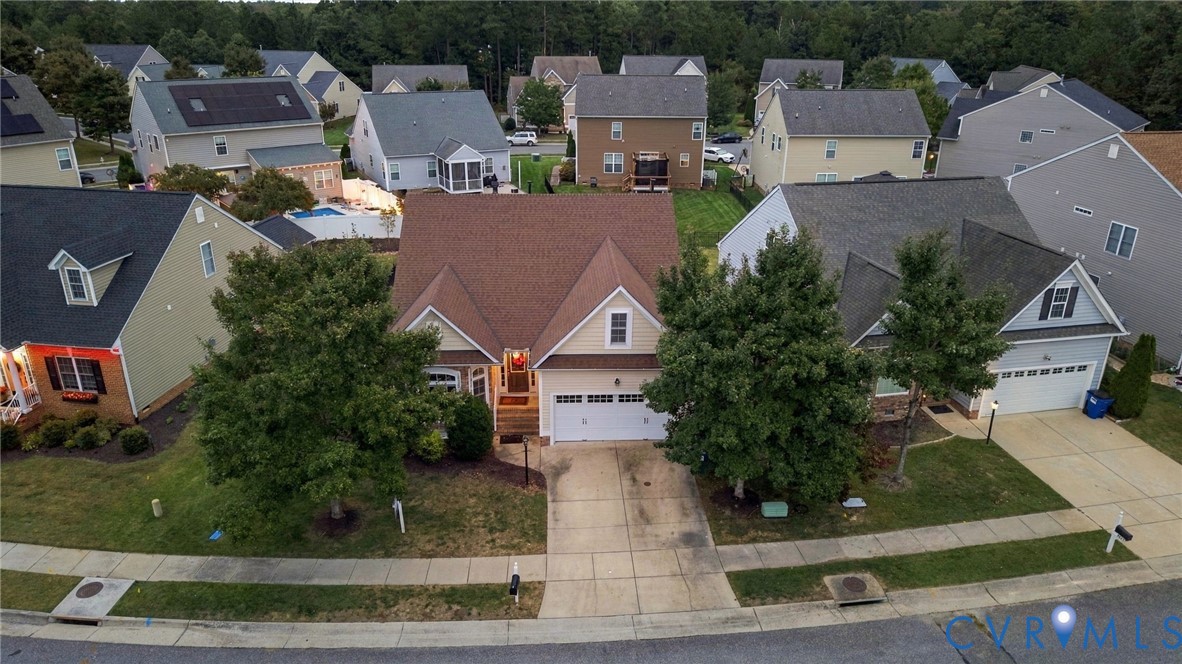 Two-story home with a two-car garage, concrete driveway, and front yard landscaping