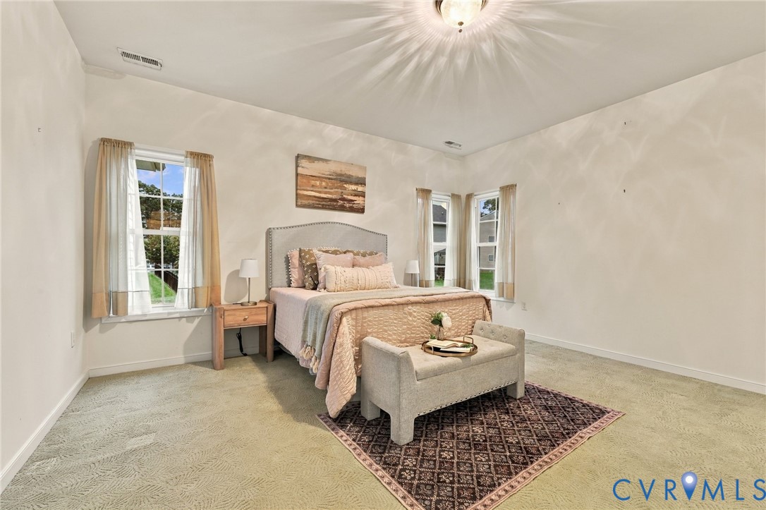 Neutral-toned walls complement plush carpeting