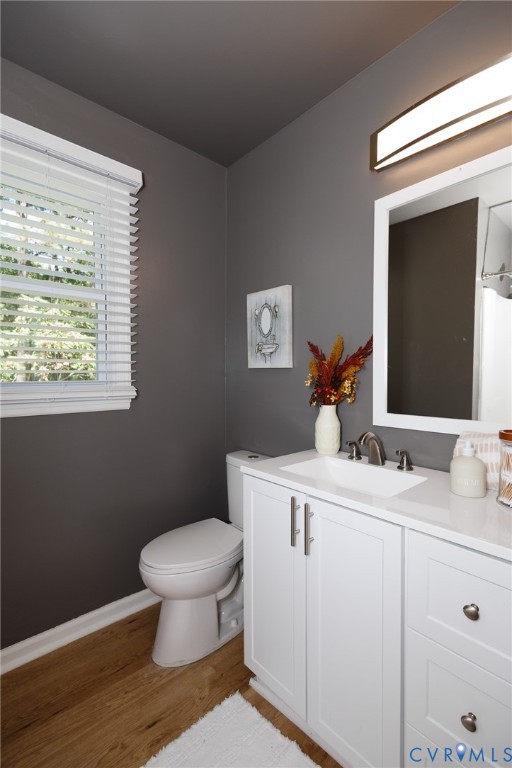 White vanity with a single basin sink, brushed nickel faucet, and integrated countertop