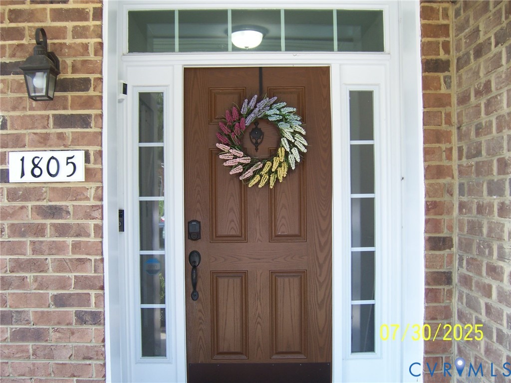 View of exterior entry featuring brick siding View of exterior entry featuring brick siding