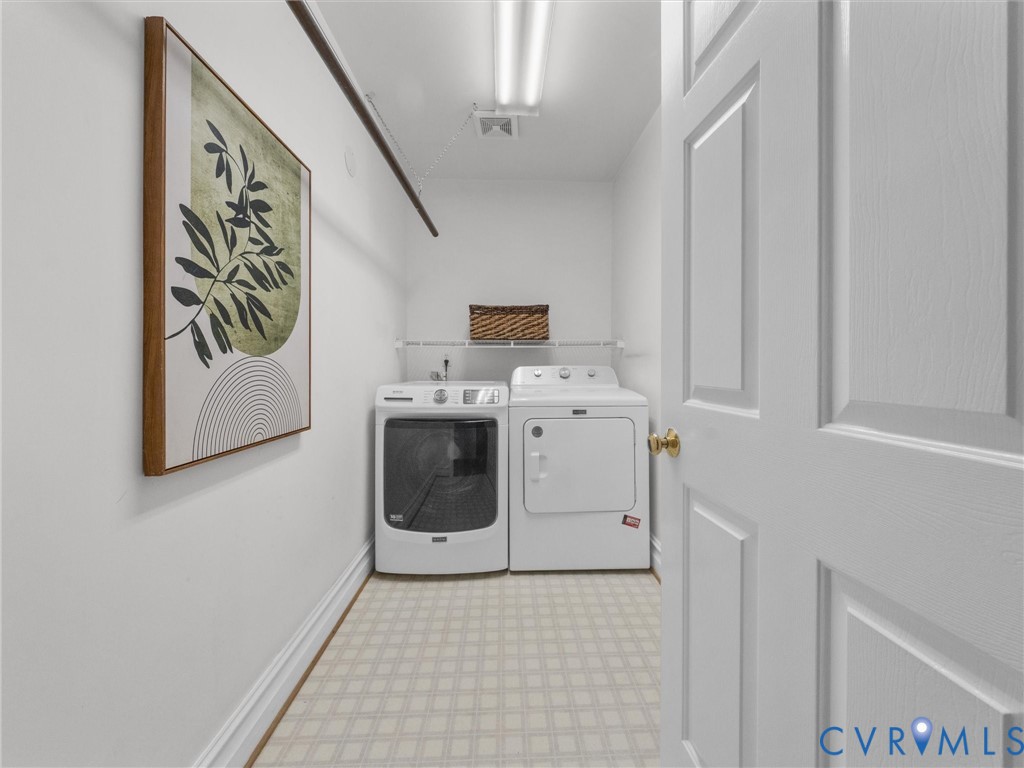 Utility room with patterned flooring, overhead lighting, and built-in shelving