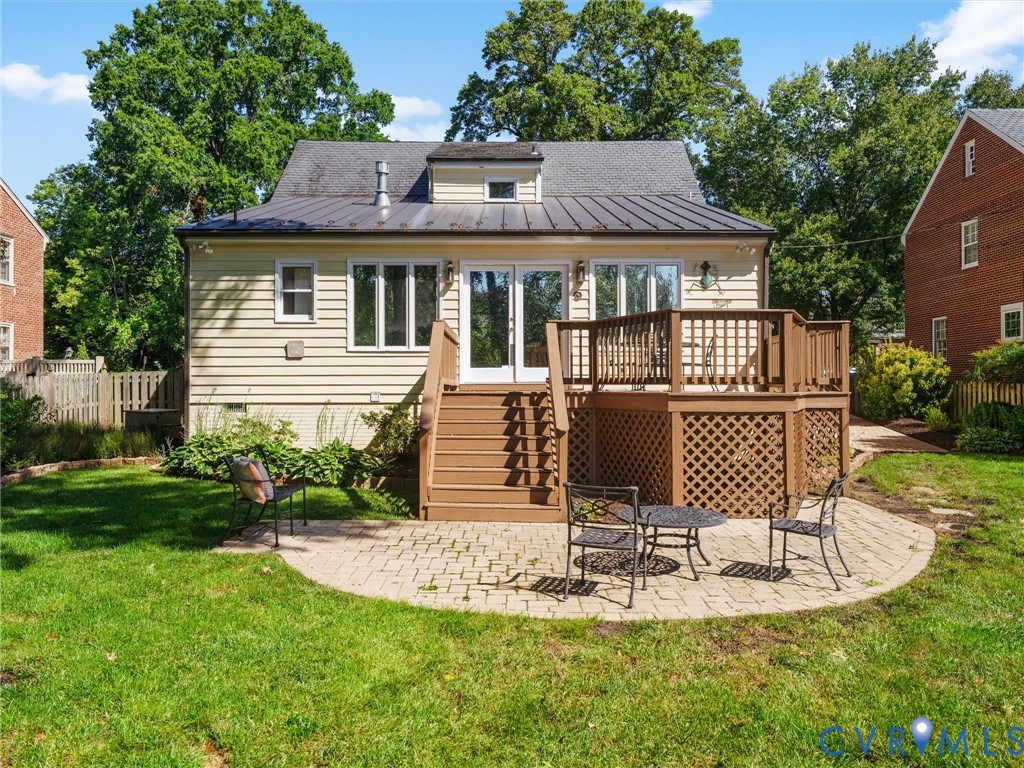 Expansive green lawn with a paver patio