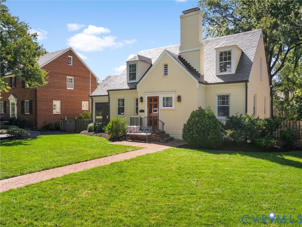 Light-colored brick exterior with a prominent chimney