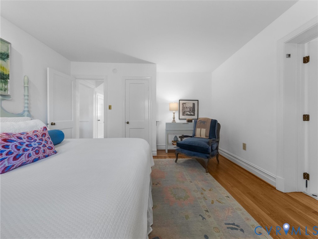 Hardwood flooring, painted white walls, and white trim