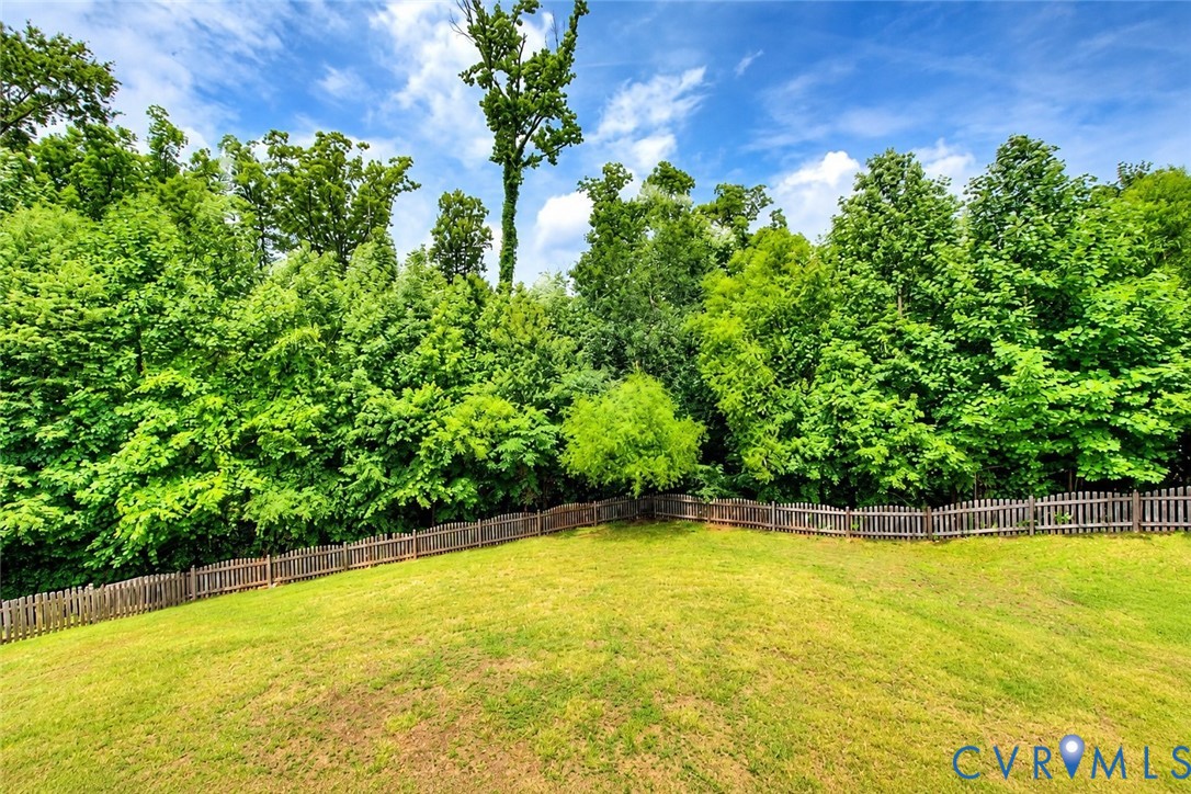 Fully fenced and lined with trees, the backyard feels like a secluded retreat. Fully fenced and lined with trees, the backyard feels like a secluded retreat.