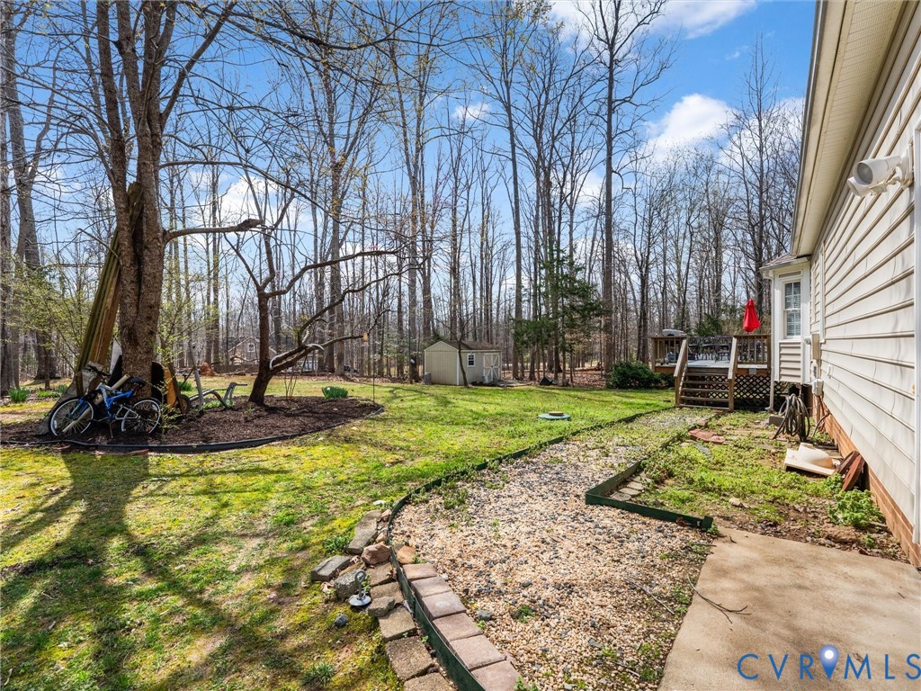 Hardscaped gravel pathway leading to a multi-level wood deck