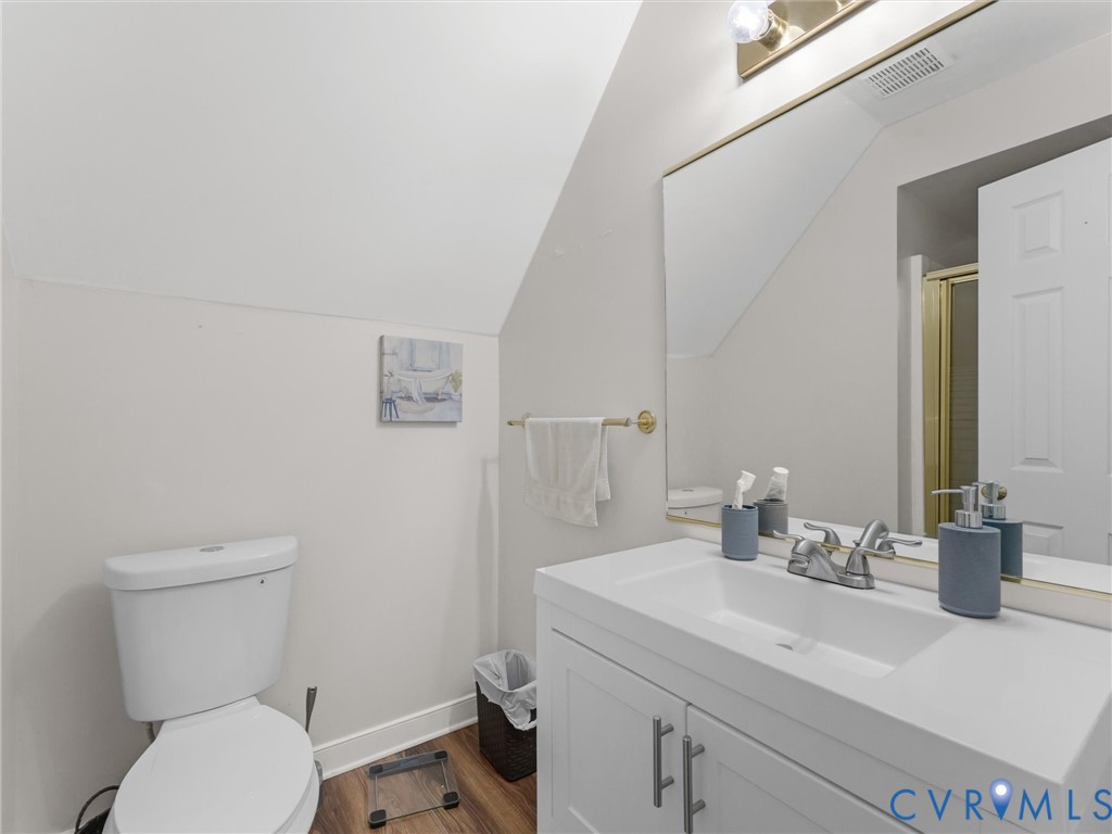 White vanity with integrated sink, chrome faucet, and brushed nickel hardware