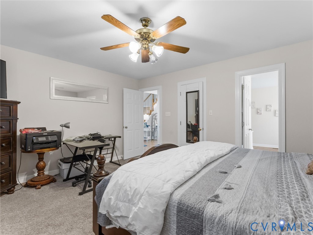 Textured carpet flooring, ceiling fan with light fixture, light neutral wall color, and white trim Textured carpet flooring, ceiling fan with light fixture, light neutral wall color, and white trim