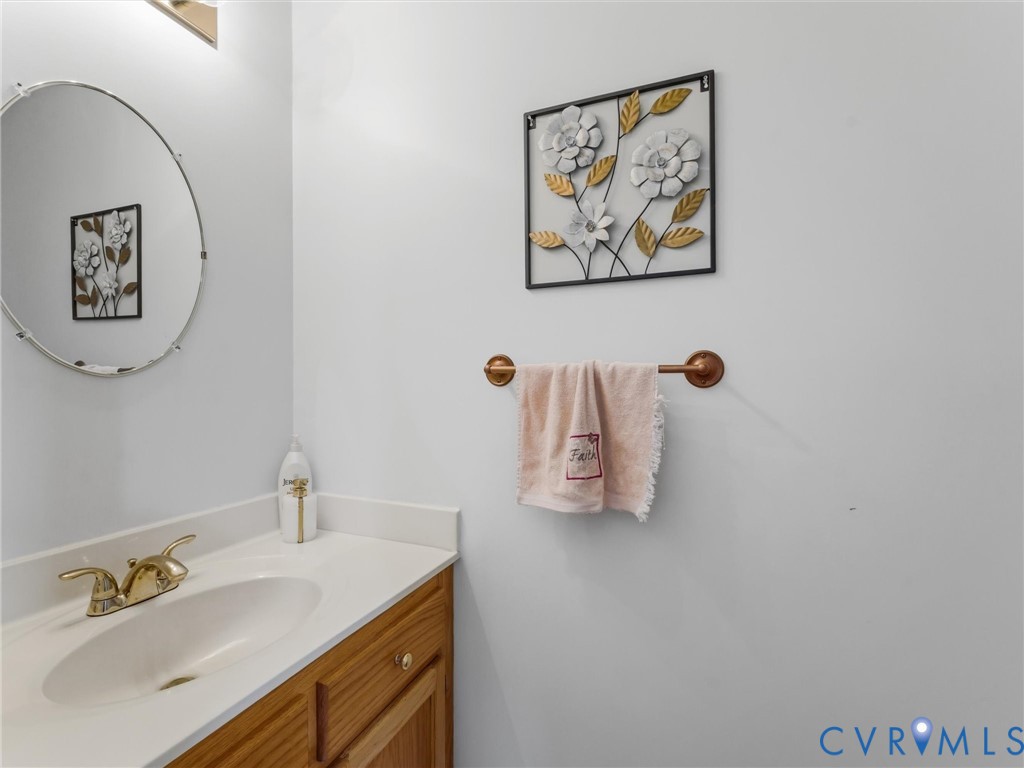 Wood-finish vanity with a white countertop and undermount sink Wood-finish vanity with a white countertop and undermount sink