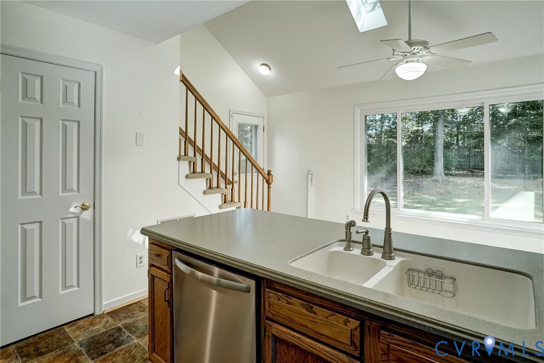 Kitchen has solid surface counter tops, pantry, eat in area and plenty of cabinet and counter space