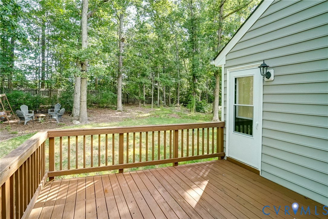 Deck over looking backyard.  It can be accessed from living room or kitchen.  Adds to the nice flow of the home