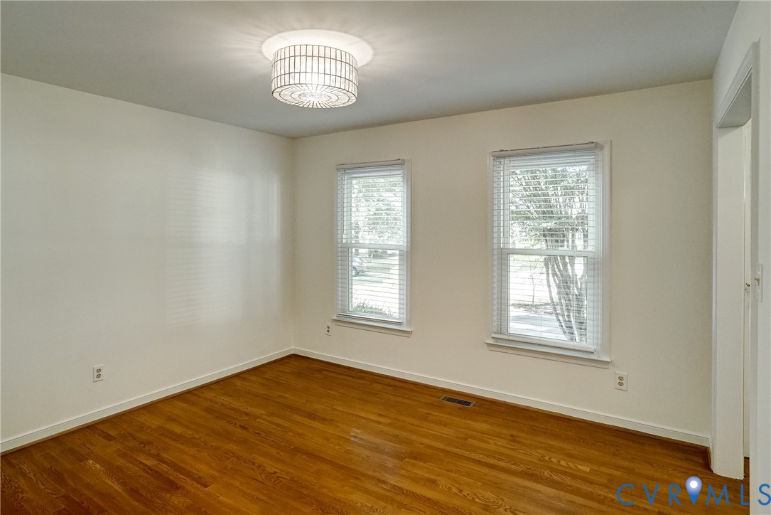 Dining room is freshly painted with hardwood floors